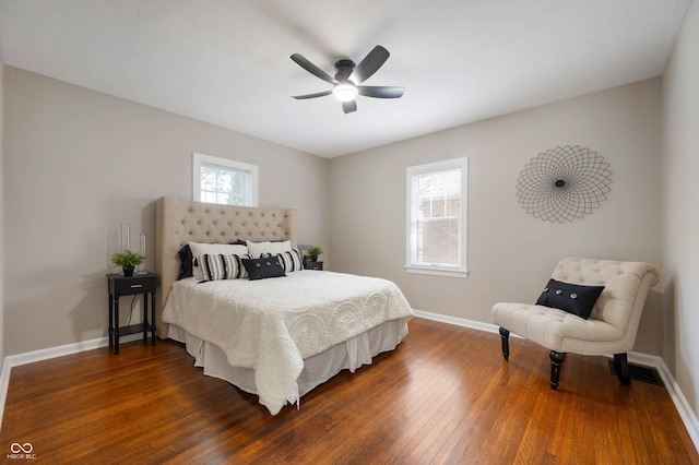 5232 E 10th St, Indianapolis, IN 46219 - bedroom with dark wood-style floors, baseboards, and ceiling fan