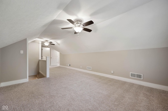 5232 E 10th St, Indianapolis, IN 46219 - bonus room with light carpet, vaulted ceiling, baseboards, and a ceiling fan