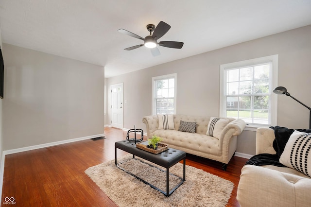 5232 E 10th St, Indianapolis, IN 46219 - living room featuring ceiling fan, plenty of natural light, baseboards, and dark wood finished floors