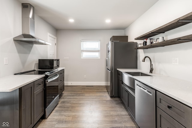 1342 N Oakland Ave, Indianapolis, IN 46201 - kitchen with wall chimney range hood, stainless steel appliances, a sink, open shelves, and light wood-type flooring