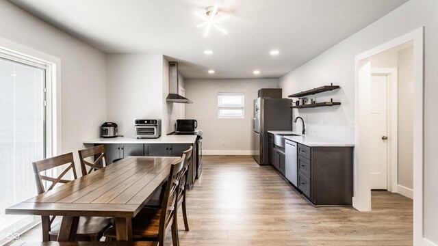 1342 N Oakland Ave, Indianapolis, IN 46201 - kitchen with wall chimney exhaust hood, light countertops, light wood-style flooring, open shelves, and recessed lighting