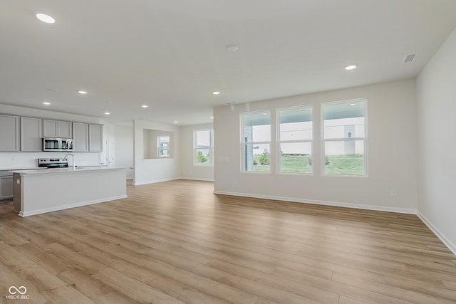 2705 Penn Ave, Plainfield, IN 46168 - unfurnished living room with light wood-style flooring and recessed lighting