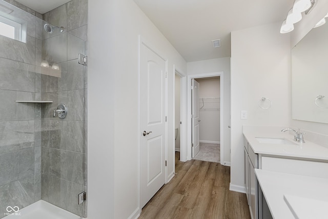 2705 Penn Ave, Plainfield, IN 46168 - full bathroom with vanity, a stall shower, wood finished floors, and a walk in closet