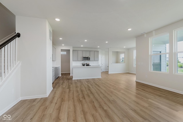 2705 Penn Ave, Plainfield, IN 46168 - unfurnished living room featuring light wood-style floors, recessed lighting, and stairs