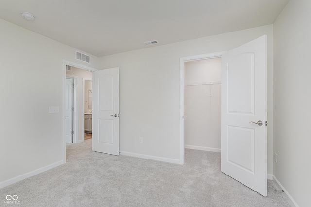 2705 Penn Ave, Plainfield, IN 46168 - unfurnished bedroom featuring light carpet, a spacious closet, and a closet