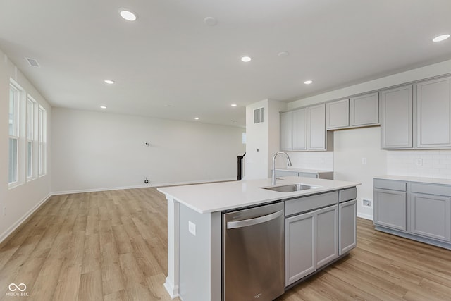 2705 Penn Ave, Plainfield, IN 46168 - kitchen featuring dishwasher, gray cabinetry, light wood-type flooring, decorative backsplash, and a kitchen island with sink