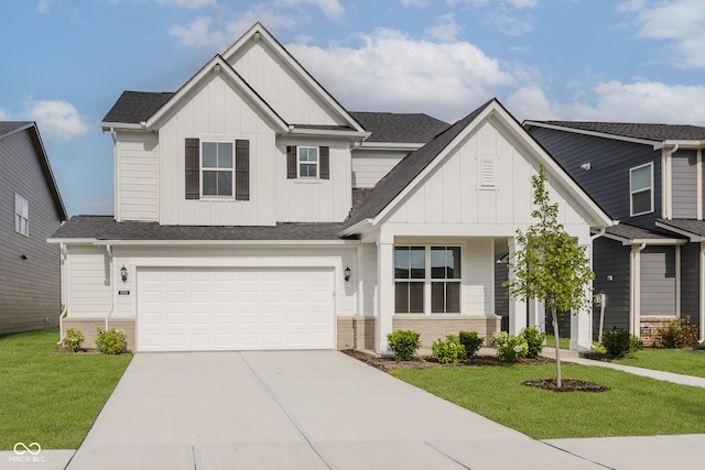 2705 Penn Ave, Plainfield, IN 46168 - view of front of home with board and batten siding, concrete driveway, a front lawn, and a garage