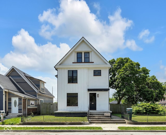 19 E Regent St, Indianapolis, IN 46225 - view of front of house featuring board and batten siding and a fenced front yard