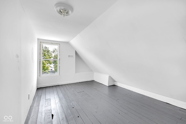 19 E Regent St, Indianapolis, IN 46225 - bonus room featuring hardwood / wood-style floors, vaulted ceiling, and baseboards