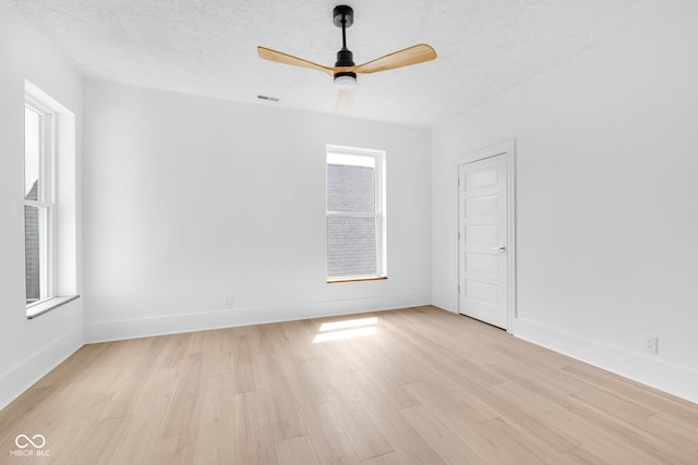 19 E Regent St, Indianapolis, IN 46225 - unfurnished room with light wood-style floors, a ceiling fan, a textured ceiling, and baseboards