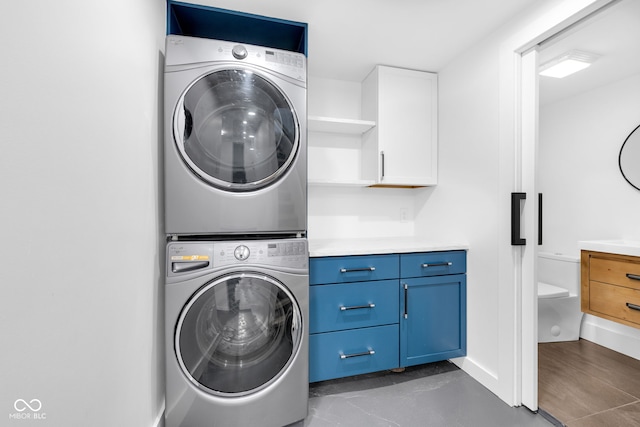 19 E Regent St, Indianapolis, IN 46225 - laundry room with stacked washer / dryer and cabinet space