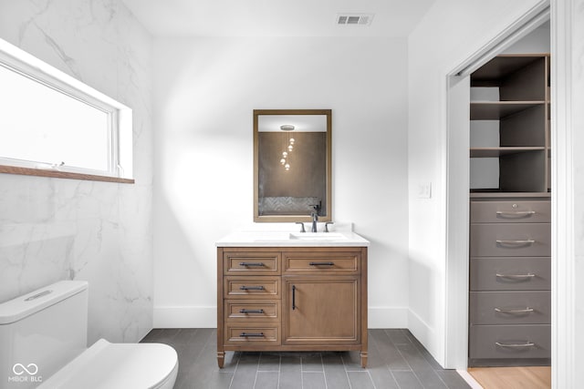 19 E Regent St, Indianapolis, IN 46225 - bathroom featuring toilet, vanity, and baseboards