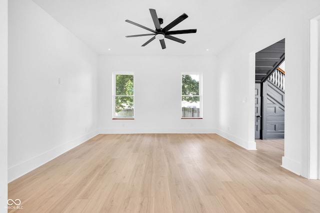 19 E Regent St, Indianapolis, IN 46225 - empty room featuring light wood-style floors, a ceiling fan, stairway, and baseboards
