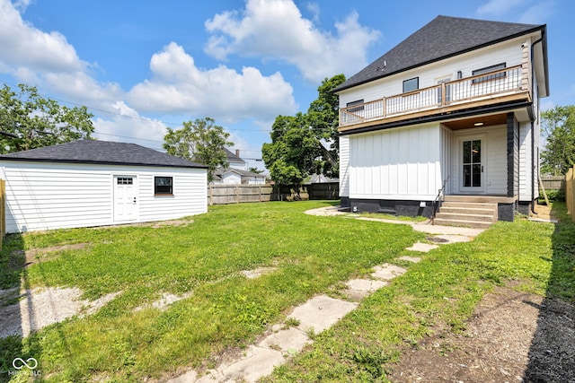 19 E Regent St, Indianapolis, IN 46225 - view of yard featuring a balcony, entry steps, and an outbuilding