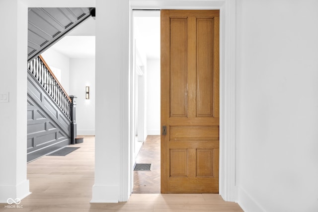 19 E Regent St, Indianapolis, IN 46225 - entryway with light wood finished floors, baseboards, and stairway
