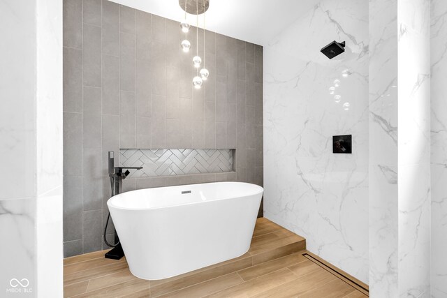 19 E Regent St, Indianapolis, IN 46225 - full bathroom with tile walls, a freestanding bath, wood finished floors, and a shower