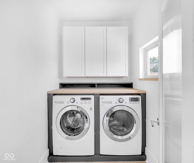19 E Regent St, Indianapolis, IN 46225 - laundry room featuring independent washer and dryer, cabinet space, and baseboards