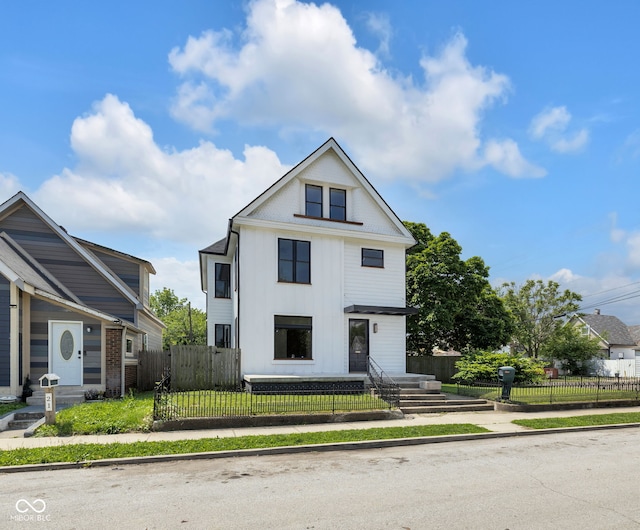 19 E Regent St, Indianapolis, IN 46225 - view of front of property with a fenced front yard and board and batten siding