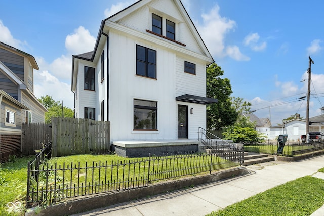19 E Regent St, Indianapolis, IN 46225 - view of front of property featuring board and batten siding