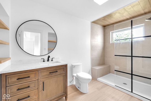 19 E Regent St, Indianapolis, IN 46225 - full bathroom featuring toilet, vanity, a tile shower, and wood finished floors