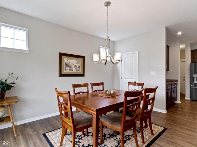 19657 Astoria Ave, Sheridan, IN 46069 - dining area with wood finished floors, a chandelier, and baseboards