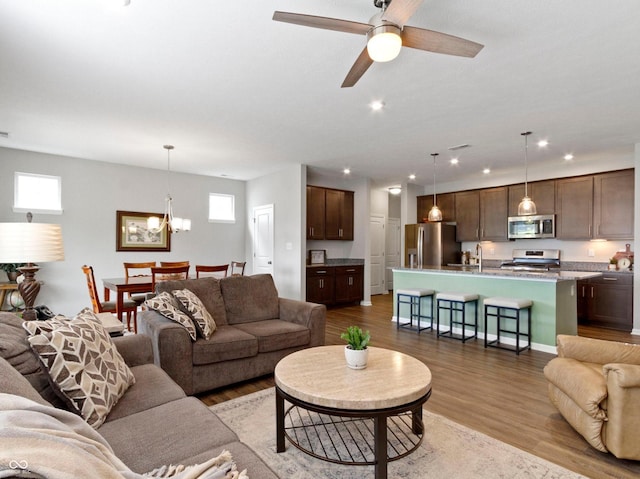 19657 Astoria Ave, Sheridan, IN 46069 - living area featuring wood finished floors, a chandelier, recessed lighting, and ceiling fan