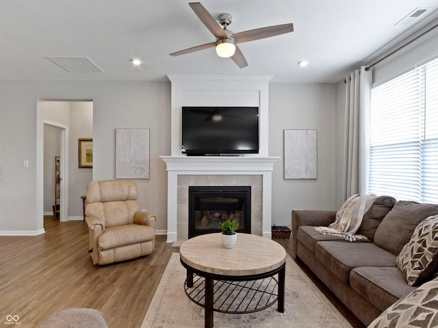 19657 Astoria Ave, Sheridan, IN 46069 - living area with light wood-type flooring, a ceiling fan, a fireplace, baseboards, and recessed lighting