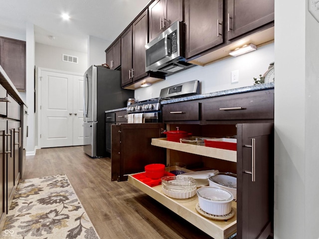 19657 Astoria Ave, Sheridan, IN 46069 - kitchen with stainless steel appliances, light wood-style flooring, and dark brown cabinets