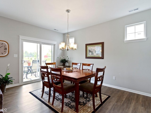 19657 Astoria Ave, Sheridan, IN 46069 - dining space featuring dark wood-style floors, a chandelier, and baseboards