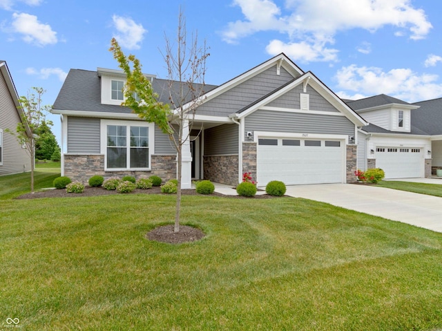 19657 Astoria Ave, Sheridan, IN 46069 - craftsman-style house featuring an attached garage, concrete driveway, stone siding, and a front lawn