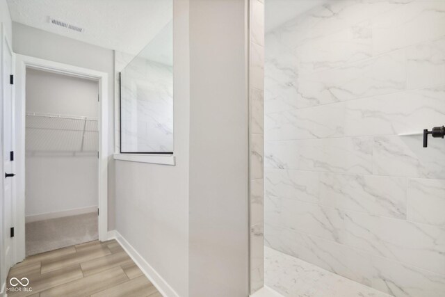 2693 Penn Ave, Plainfield, IN 46168 - full bath with a marble finish shower, wood finished floors, a spacious closet, and baseboards