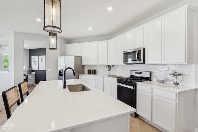 2693 Penn Ave, Plainfield, IN 46168 - kitchen with stainless steel appliances, a sink, decorative backsplash, light countertops, and recessed lighting