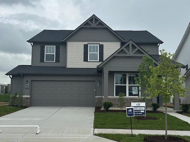 2693 Penn Ave, Plainfield, IN 46168 - craftsman house with stone siding, concrete driveway, a garage, a front yard, and a shingled roof