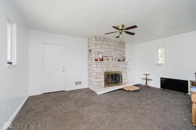 4232 Linden Ln, Anderson, IN 46011 - unfurnished living room with ceiling fan, carpet flooring, and a stone fireplace