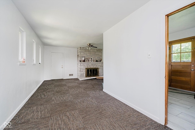 4232 Linden Ln, Anderson, IN 46011 - unfurnished living room featuring ceiling fan, a stone fireplace, and carpet floors