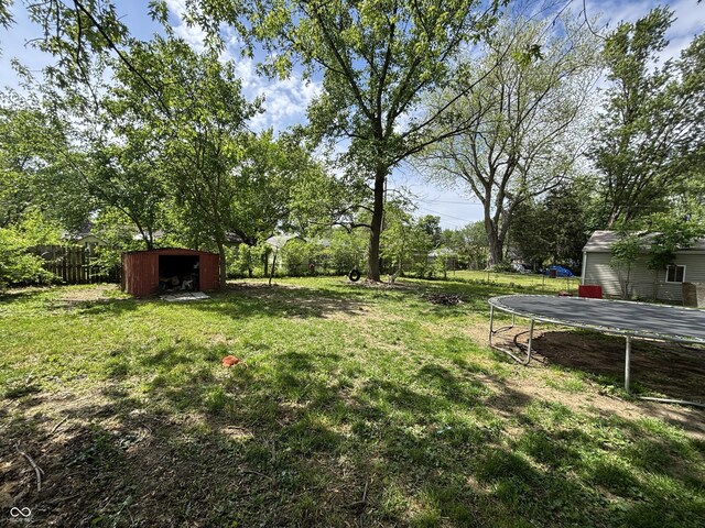 2015 Rosewood Dr, Anderson, IN 46011 - view of yard with a trampoline, a storage unit, and an outbuilding