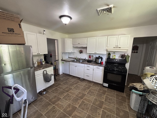 2015 Rosewood Dr, Anderson, IN 46011 - kitchen featuring freestanding refrigerator, under cabinet range hood, black gas range oven, white dishwasher, and white cabinets