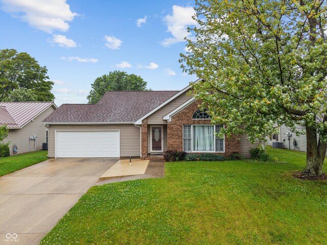 485 Mesa Dr, Russiaville, IN 46979 - view of front facade with a garage, a front yard, and driveway