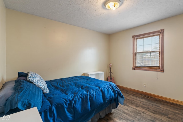 485 Mesa Dr, Russiaville, IN 46979 - bedroom with wood finished floors, baseboards, and a textured ceiling