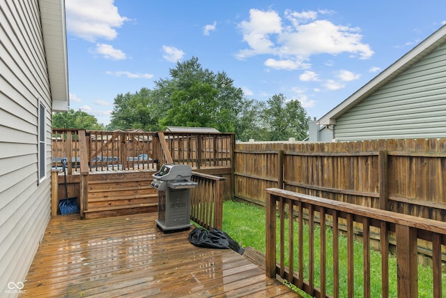 485 Mesa Dr, Russiaville, IN 46979 - wooden deck with area for grilling and a fenced backyard