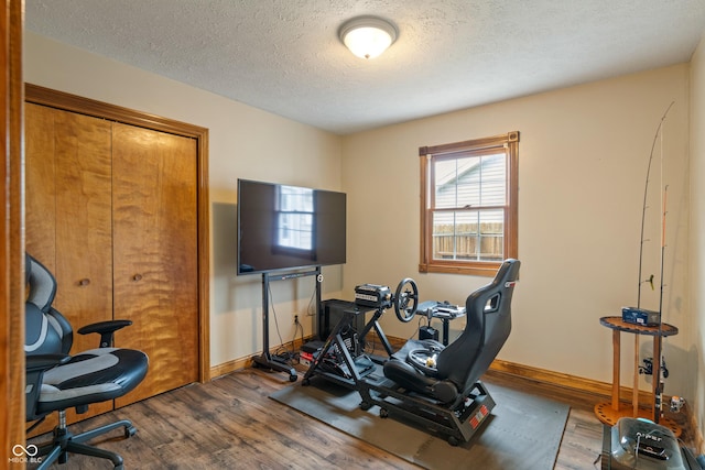 485 Mesa Dr, Russiaville, IN 46979 - workout room featuring wood finished floors, baseboards, and a textured ceiling