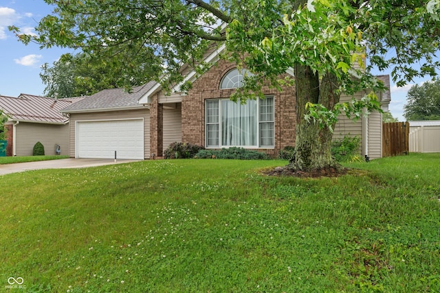 485 Mesa Dr, Russiaville, IN 46979 - view of front facade with an attached garage, brick siding, and driveway