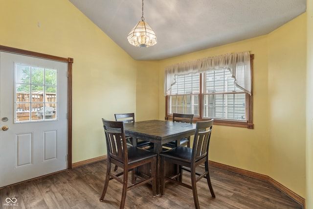 485 Mesa Dr, Russiaville, IN 46979 - dining area featuring a chandelier, dark wood-style flooring, baseboards, and vaulted ceiling