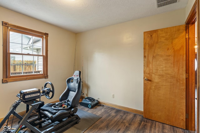 485 Mesa Dr, Russiaville, IN 46979 - workout room featuring wood finished floors, baseboards, and a textured ceiling