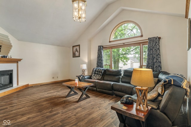485 Mesa Dr, Russiaville, IN 46979 - living room with wood finished floors, high vaulted ceiling, a chandelier, a fireplace with raised hearth, and baseboards