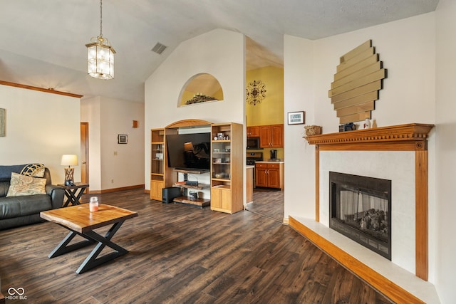 485 Mesa Dr, Russiaville, IN 46979 - living area with dark wood-style floors, a tiled fireplace, high vaulted ceiling, a chandelier, and baseboards