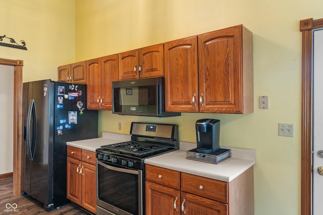 485 Mesa Dr, Russiaville, IN 46979 - kitchen featuring appliances with stainless steel finishes, light countertops, dark wood-style floors, and brown cabinets