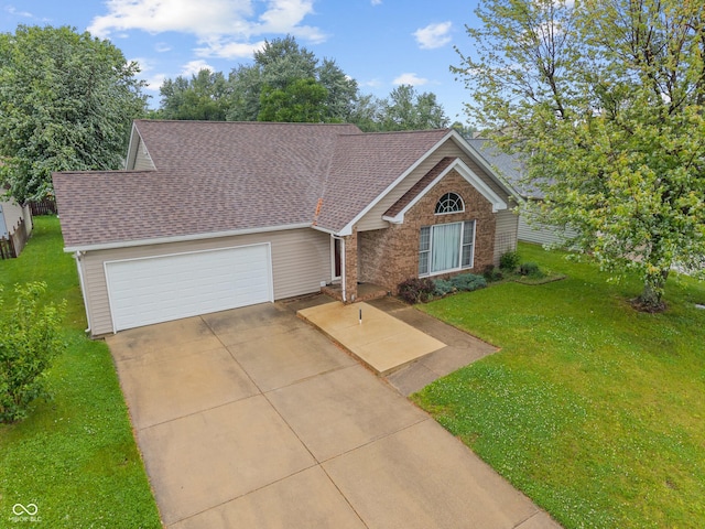 485 Mesa Dr, Russiaville, IN 46979 - view of front of house with a garage, a front yard, driveway, and brick siding