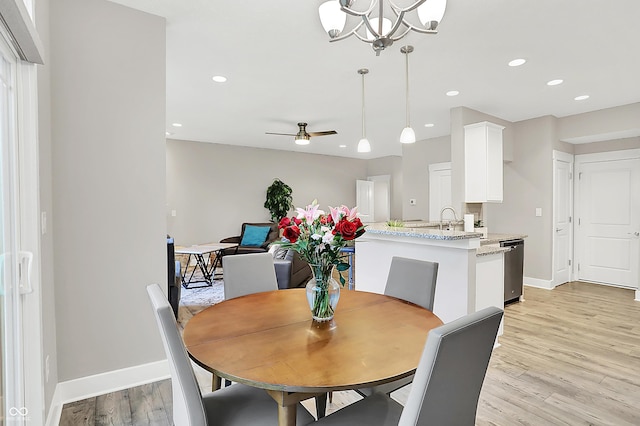 8266 Glacier Ridge Dr, Fishers, IN 46038 - dining space with light wood-style floors, baseboards, ceiling fan, recessed lighting, and a chandelier