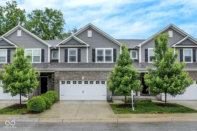 8266 Glacier Ridge Dr, Fishers, IN 46038 - view of front facade with driveway, roof with shingles, a garage, and brick siding